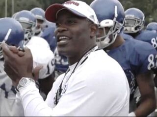 Jayhawks coach Turner Gill with his team (KUAthletics on YouTube)