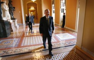 Senate Minority Leader Mitch McConnell walks to the Senate chamber.