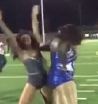 Shamyra Cooper (right), 15, turned her back on a member of a rival drill team, who appeared to pull the teen’s hair, triggering an all-out brawl between the two rival schools in Dallas Sept. 18, 2015.Fox 26 Screenshot