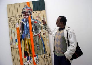 Fab 5 Freddy with a work by Basquiat (Getty Images)