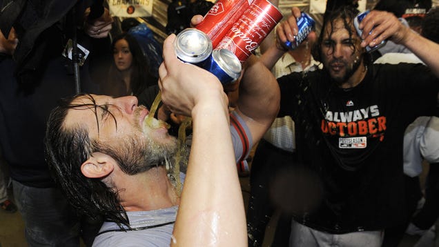 Madison Bumgarner &quot;drinks&quot; four beers at once while celebrating his shutout. Photo by Jaso