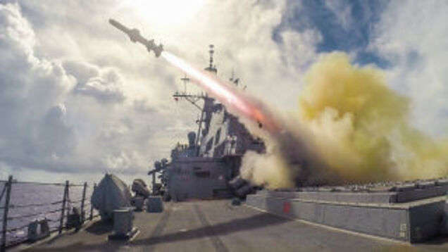 A US Navy guided-missile destroyer fires a Harpoon missile ...
