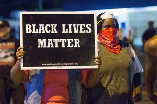 Demonstrators marking the one-year anniversary of the shooting of Michael Brown protest along West Florissant Street Aug. 10, 2015, in Ferguson, Mo.Scott Olson/Getty Images