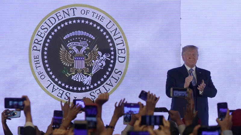 Illustration for article titled Trump Gives Speech in Front of Altered Presidential Seal Featuring Golf Clubs and ‘45 Is a Puppet’