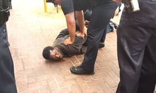 Police officers restrain the unidentified man in San Francisco Aug. 4, 2015.YouTube screenshot