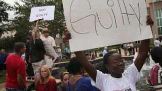 Dueling demonstrators outside the Sanford, Fla., courthouse await a verdict. (Scott Olson/Getty Images)