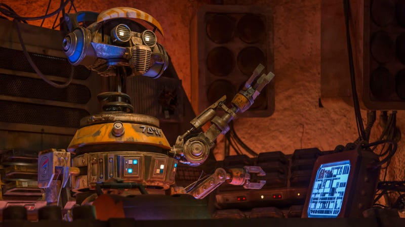 DJ R-3X used to fly for Star Tours, but heâs now a DJ on Batuu.