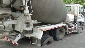 Illustration for article titled Cement truck gets stuck in road