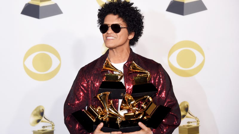 Bruno Mars poses with the five Grammys he won during the 60th annual show Jan. 28, 2018, in New York City.