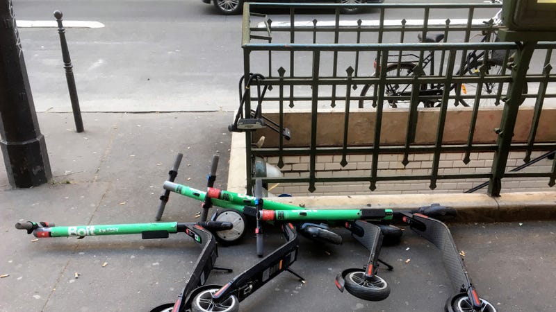 Electric scooters for sharing lay on the sidewalk outside a subway station in Paris, Thursday, March 21, 2019.