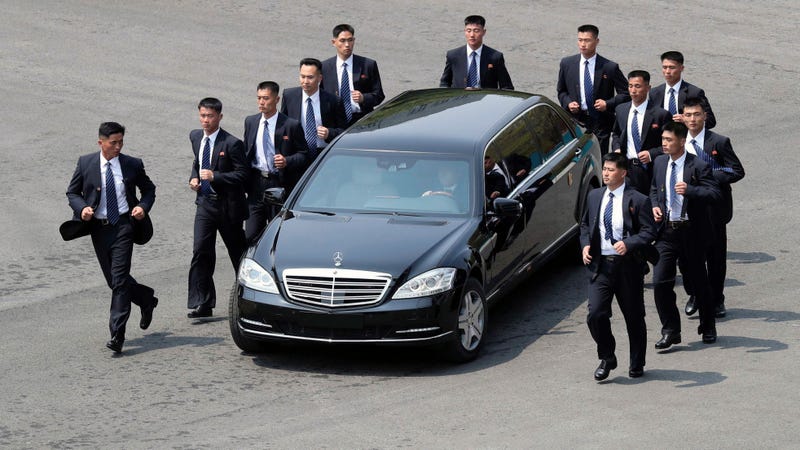North Korean security persons run by a car carrying North Korean leader Kim Jong Un return to the North side for a lunch break after a morning session of a summit meeting with South Korean President Moon Jae-in at the border village of Panmunjom in Demilitarized Zone Friday, April 27, 2018. Their discussions will be expected to focus on whether the North can be persuaded to give up its nuclear bombs. (Korea Summit Press Pool via AP)