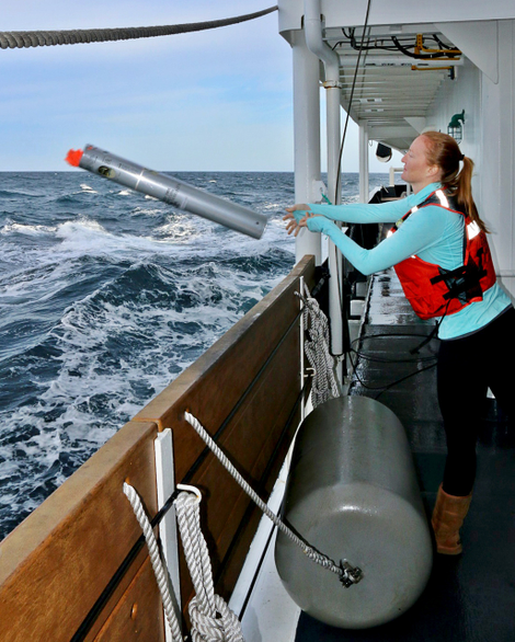 Marine biologist Jessica Crance throws a sonobuoy into the ocean to acoustically monitor for North Pacific right whale calls.