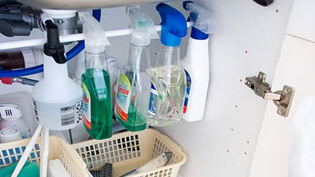 Organize Cleaning Bottles Under The Sink With A Tension Rod