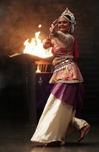 Illustration for article titled Gorgeously Bejeweled Dancer Fans Flames