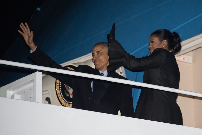 President Barack Obama and first lady Michelle Obama wave before boarding Air Force One at Andrews Air Force Base in Maryland on Dec. 16, 2016, as they depart for their Christmas holiday in Hawaii.NICHOLAS KAMM/AFP/Getty Images