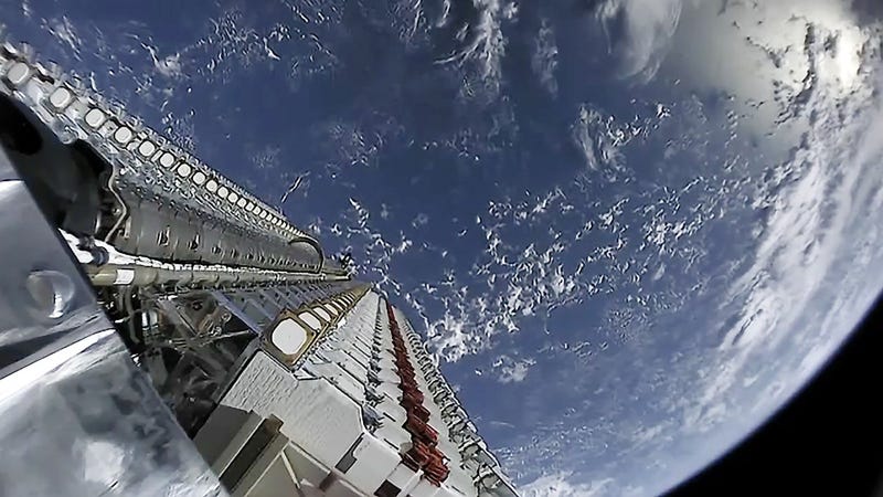 The first batch of 60 Starlink satellites just prior to deployment in low Earth orbit.