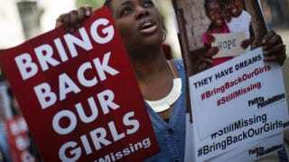 A woman holds a sign as other protesters gather outside the Nigeria House in London April 14, 2015, to mark the one-year anniversary since a group of Nigerian schoolgirls were abducted in Nigeria. Dan Kitwood/Getty Images