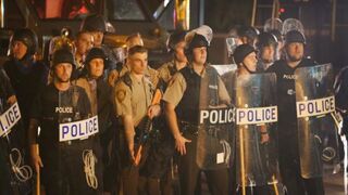 On Aug. 19, 2014, police watch as demonstrators in Ferguson, Mo., protest the killing of teenager Michael Brown, who was fatally shot by a Ferguson police officer on Aug. 9.Scott Olson/Getty Images