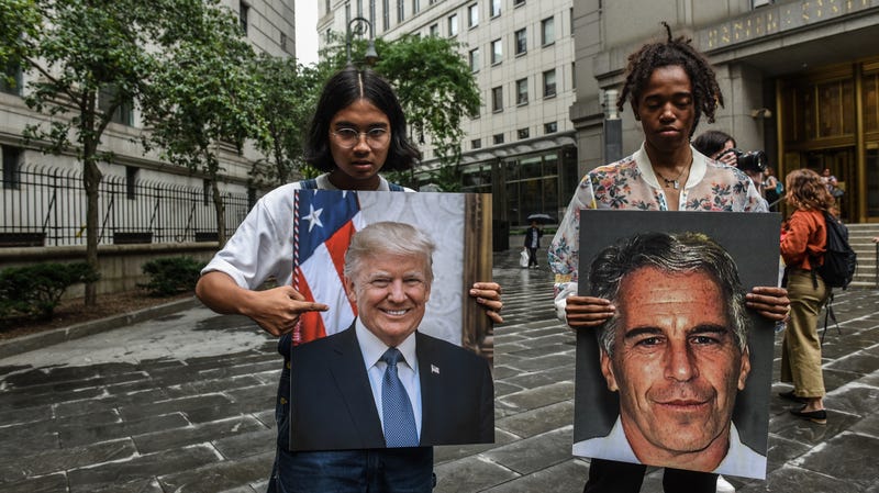 Protesters hold signs of Jeffrey Epstein and President Donald Trump in front of the Federal courthouse in New York City.