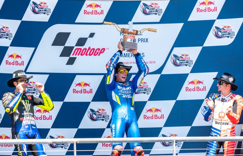 Alex Rins (center) flanked by Valentino Rossi (left) and Jack Miller (right).