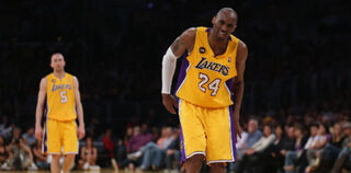 Kobe Bryant limps on the court on April 12, 2013. (Jeff Gross/Getty Images)