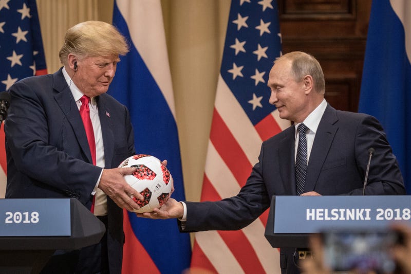 Russian President Vladimir Putin hands U.S. President Donald Trump (L) a World Cup football during a joint press conference after their summit on July 16, 2018 in Helsinki, Finland. The two leaders met one-on-one and discussed a range of issues including the 2016 U.S Election collusion.