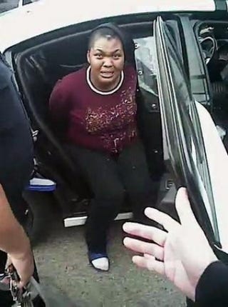 Charlena Michelle Cooks in the back of the police cruiserYouTube