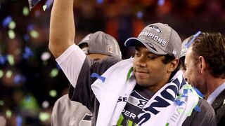 EAST RUTHERFORD, NJ - FEBRUARY 2: Quarterback Russell Wilson #3 of the Seattle Seahawks celebrates with the Vince Lombardi Trophy after their 43-8 victory over the Denver Broncos during Super Bowl XLVIII at MetLife Stadium on February 2, 2014 in East Rutherford, New Jersey.Photo by Jeff Gross/Getty Images