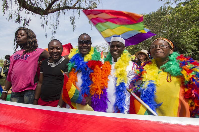 People hold rainbow flags as they take part in the gay-pride parade in Entebbe, Uganda, on Aug. 8, 2015.ISAAC KASAMANI/AFP/Getty Images