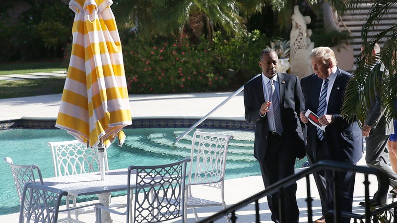 Then-candidate Donald Trump speaks with Dr. Ben Carson, now the secretary of Housing and Urban Development, by a pool at the Mar-a-Lago Club in 2016.