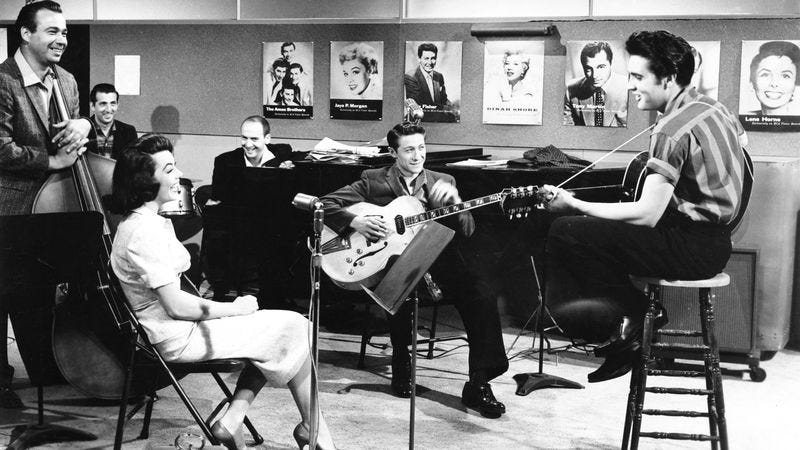 Scotty Moore (center) and Elvis Presley, on the set of Jailhouse Rock. (Photo: Getty Images)
