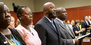 Trayvon's parents, who averted their eyes when the image of their son's dead body was shown during the trial (Getty Images)