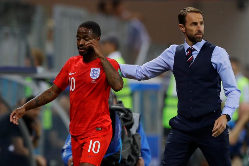 Gareth Southgate walks off Raheem Sterling after subbing him out against Tunisia.