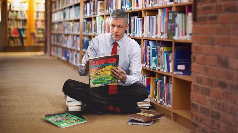 Arne Duncan Spends Visit To Local Elementary School Looking At Ufo Books In Library