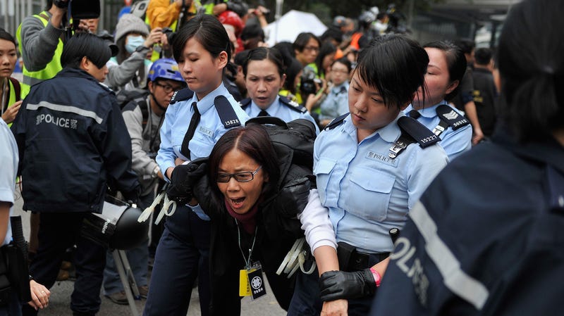 A protester is arrested and carried away by police officers during the 2014 protests