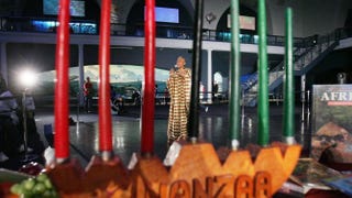 Camille Yarborough sings African music behind a traditional kinara during a preview of the “Kwanzaa 2004: We Are Family” festival at the American Museum of Natural History, Dec. 22, 2004, in New York City.Mario Tama/Getty Images