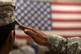A soldier salutes the flag during a welcome-home ceremony for troops arriving in Fort Carson, Colo., from Afghanistan June 15, 2011.John Moore/Getty Images