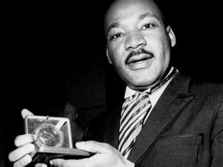 Martin Luther King Jr. holding the Nobel Peace Prize he won in 1964.Youtube
