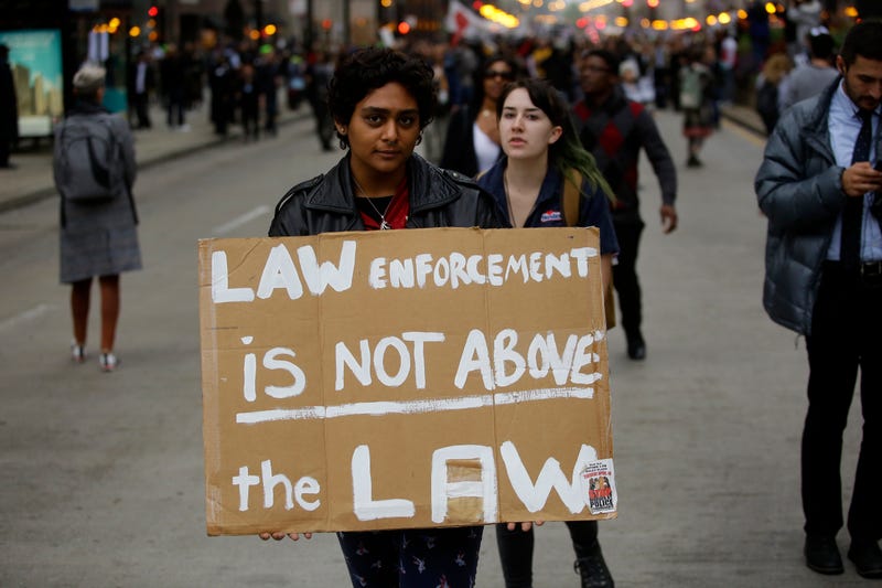 Demonstrators protest as they celebrate the verdict in the murder trial of Chicago police officer Jason Van Dyke along Michigan Avenue on Oct. 5, 2018, in Chicago.