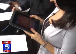 Illustration for article titled Local News Team Tricks Anchor Into Licking iPad
