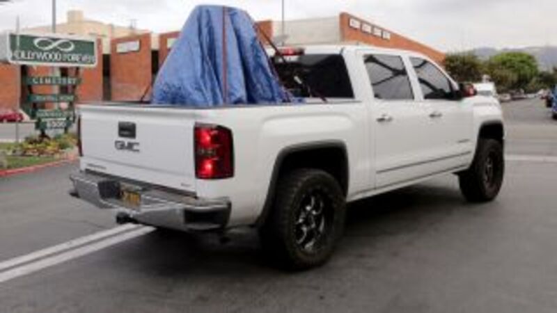 A monument honoring Confederate soldiers is covered in blue tarp after being removed from the Hollywood Forever Cemetery  on Aug. 16, 2017, in Los Angeles. (Irfan Khan/Getty Images)