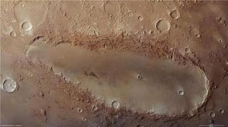 Illustration for article titled This bizarre elongated crater is a Martian mystery