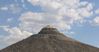 Illustration for article titled A House Shaped Like a Flying Saucer, Perched Atop a Volcano