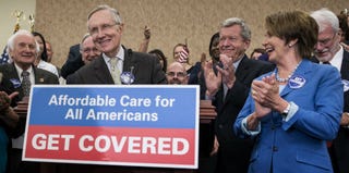 Senate Majority Leader Harry Reid and House Minority Leader Nancy Pelosi celebrate the ACA Oct 1. (Getty Images)