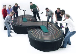 Illustration for article titled 8 Lane Scalextric Slot Racer Track: The Ultimate Team Building Gadget