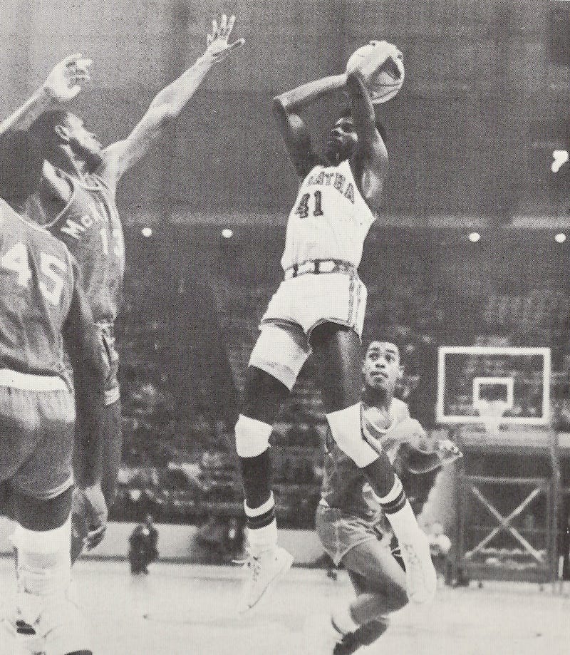 DeMatha’s James Brown shooting over future NBA vet Tim Bassett of rival McKinley Tech in 1969 game.