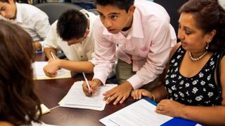 Young immigrants fill out paperwork. (Paul J. Richards/AFP/Getty Images)