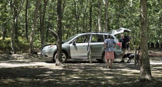 A woman waits as her car is searched near where President Barack Obama golfs at Farm Neck Golf Club on Aug. 12, 2015, in Oak Bluffs on Martha’s Vineyard, Mass. BRENDAN SMIALOWSKI/AFP/Getty Images