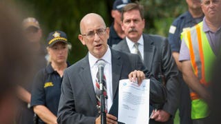 Then-Chicago Police Department Chief of Detectives John Escalante shows off a community-alert flier while speaking to the press in Chicago on Sept. 9, 2015.Scott Olson/Getty Images