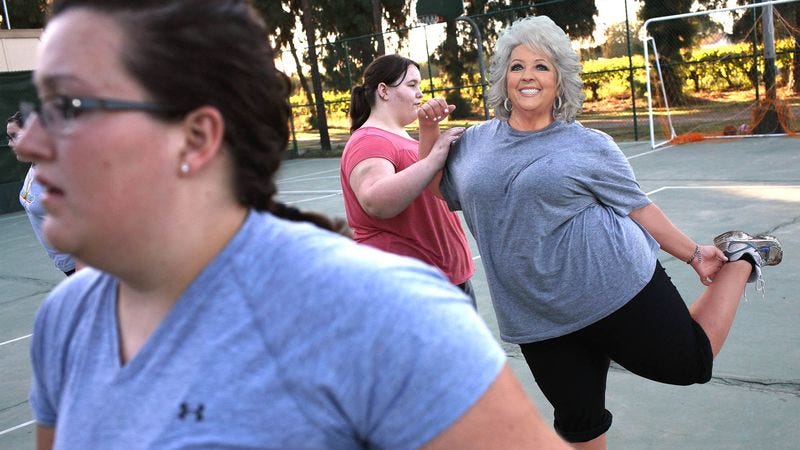 Deen and participants stretch while training for the 164-foot charity walk.